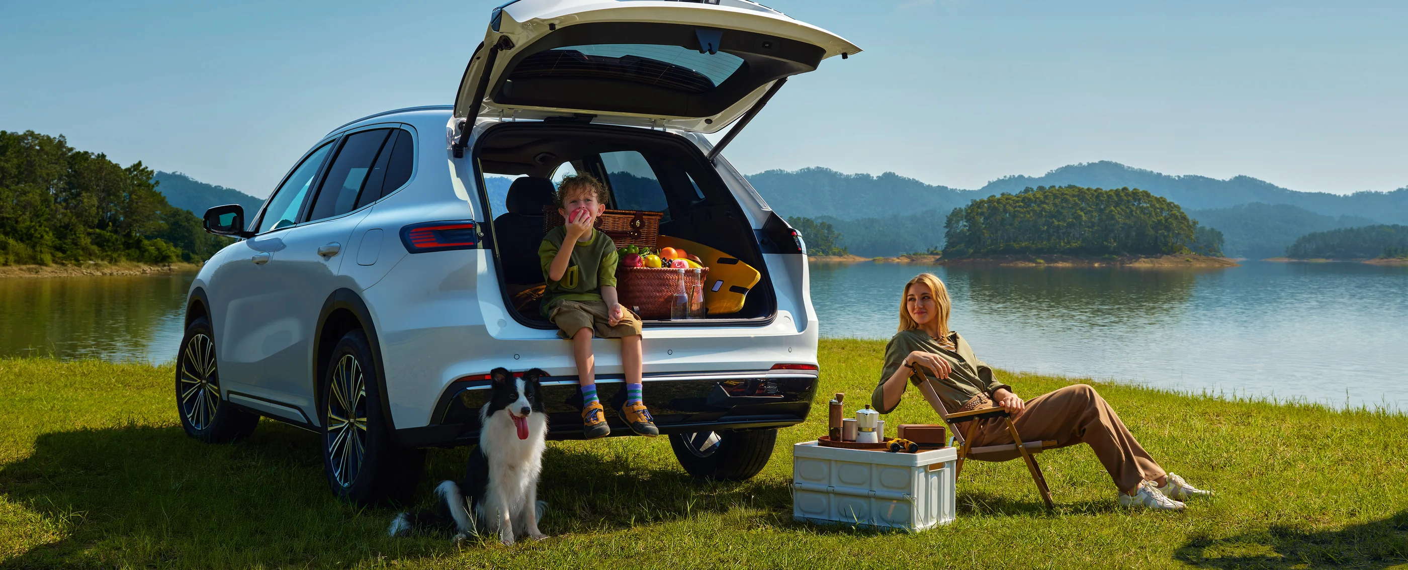 Geely E5 EM-i parked lakeside with its tailgate open